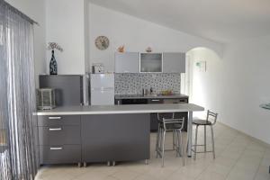 a kitchen with a counter and a refrigerator at Apartment Hvar Bike in Stari Grad