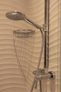 a shower with a shower head in a bathroom at Villa Mirella in Bordighera