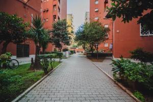 an empty street in a city with tall buildings at Lady Butterfly - Metro A Lucio Sestio in Rome