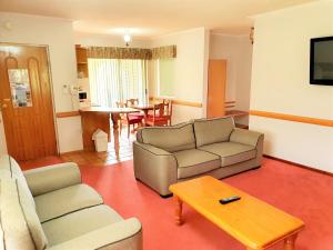 a living room with a couch and a table at McNevins Warwick Motel in Warwick