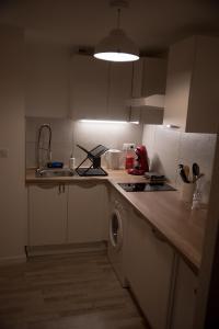 a kitchen with a sink and a washing machine at Calme et cosy in Obernai