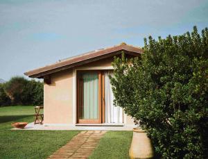 a small house with a window in a field at Inghirios Wellness Country Resort in Santa Maria la Palma