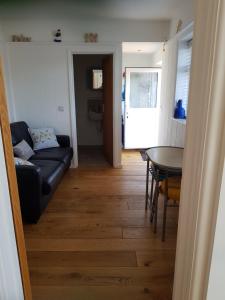 a living room with a couch and a table at The Slopes in Whitstable