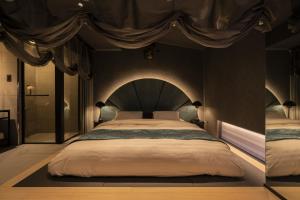 a bedroom with a large bed with a canopy at moire HOTEL YOSHIWARA in Tokyo