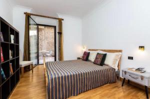a bedroom with a large bed and a window at Ghetto Apartment with balcony in Rome