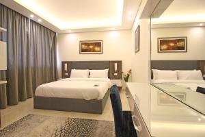 Postel nebo postele na pokoji v ubytování Palm Ville Suites