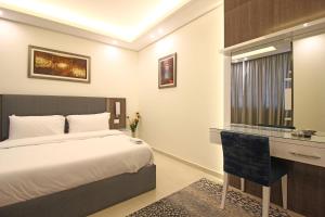 Postel nebo postele na pokoji v ubytování Palm Ville Suites