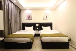 Postel nebo postele na pokoji v ubytování Palm Ville Suites