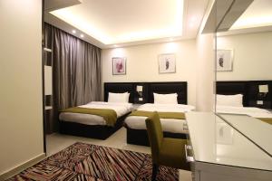Postel nebo postele na pokoji v ubytování Palm Ville Suites