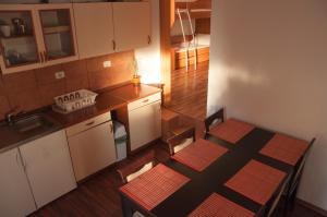 a small kitchen with a table and chairs in a room at Apartment Beli Kriz in Piran