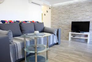 TV a/nebo společenská místnost v ubytování Pearl Apartment