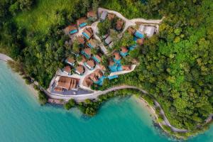 eine Luftaufnahme eines Resorts neben einem Gewässer in der Unterkunft Sinae Phuket - SHA Extra Plus in Phuket