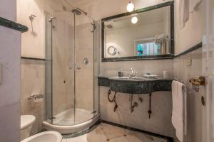 a bathroom with a shower and a sink and a toilet at Hotel Emona Aquaeductus in Rome +82 photos