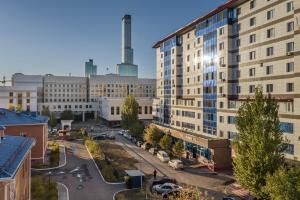 an aerial view of a city with tall buildings at Rush Inn Hotel in Astana
