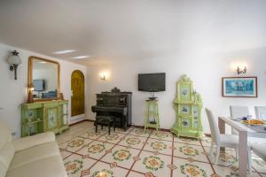 een woonkamer met een tafel en een piano bij Casa Albatros in Praiano