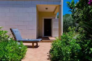 a blue chair sitting in front of a house at Private Garden Apartment Dubrovnik in Dubrovnik