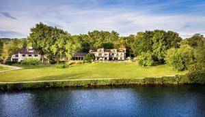 an aerial view of a house by the water at Relais & Châteaux Hôtel La Réserve in Albi