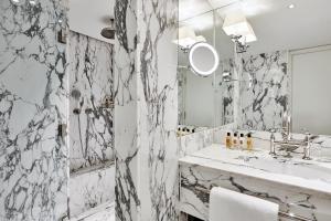 
a bathroom with a sink and a mirror at De L’Europe Amsterdam – The Leading Hotels of the World in Amsterdam
