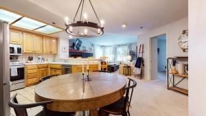 a large kitchen with a wooden table and chairs at Silver Bear #21 condo in Mammoth Lakes