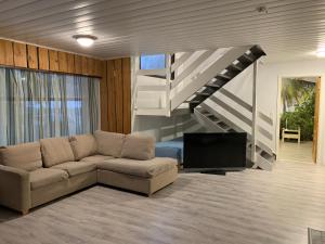 a living room with a couch and a staircase at Revontuli Apartments in Rovaniemi