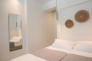 A bed or beds in a room at Rivière Residence Paros
