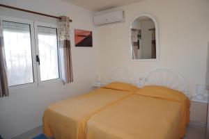 a white bedroom with a bed and two windows at Villa LILAS in Els Poblets in Els Poblets +28 photos