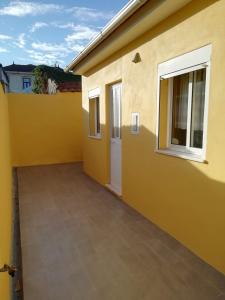 a yellow house with a door and a window at Al Gaia Centro Historico in Vila Nova de Gaia