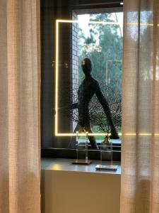 a statue of a man standing in a window at DS Hotel Lusopark in Santa Maria Da Feira