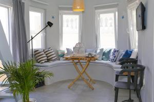 a living room with a couch and a table at Camara Homes in Andros