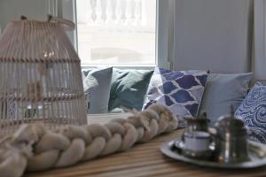 a table with a lamp and a plate of food at Camara Homes in Andros