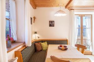 a living room with a table and a couch at Ferienwohnung Guffertblick in Jachenau