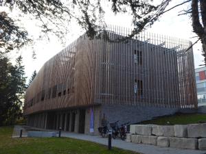 a building with a wooden facade with bikes parked in front at Studio Apartment 2 in Tübingen