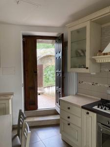 a kitchen with a door leading to a patio at Piedirocca Apartments in Roccantica