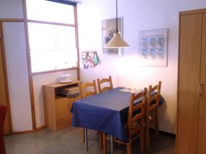 a dining room with a blue table and chairs at Fewo 91 WHG B 15 in Burhave in Burhave