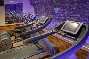 a gym with a row of cardio machines at Ambleside Salutation Hotel & Spa, World Hotel Distinctive in Ambleside