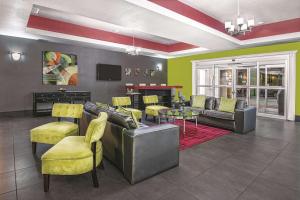 a living room with a couch and chairs and a table at La Quinta by Wyndham Laredo Airport in Laredo