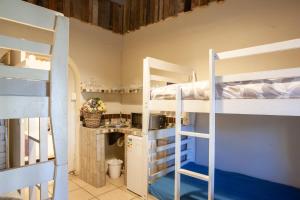 a room with two bunk beds and a kitchen at Strand Scouty`s Place - 6 Sleeper Helderberg CT in Cape Town