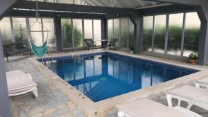 a swimming pool in a house with a patio at Holiday Home Bogumila in Risan