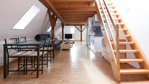 a room with a table and chairs and a staircase at Swiss Star Zurich Sihlfeld - Self Check-In in Zurich