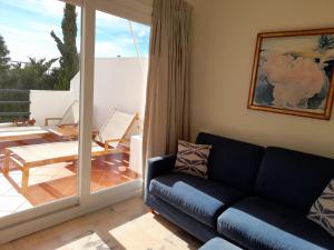 a living room with a couch and a patio at miKasa Agua Amarga & SPA in Agua Amarga