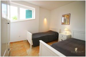 Posteľ alebo postele v izbe v ubytovaní SeaView Apartment - Rogoznica + 2 fotografie