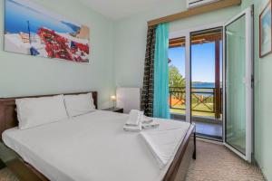 a bedroom with a bed and a view of the ocean at Villa Laguna in Vourvourou +78 photos