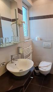 a bathroom with a sink and a toilet at Hotel Prox in Arnstadt