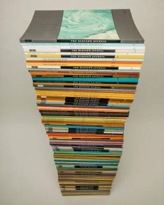 a stack of books on top of each other at Ait Mouli Surf House in Safi