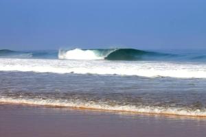 a large wave in the ocean on a beach at Ait Mouli Surf House in Safi