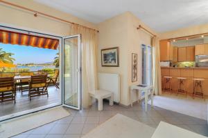 a kitchen and dining room with a view of the ocean at Villa Laguna in Vourvourou