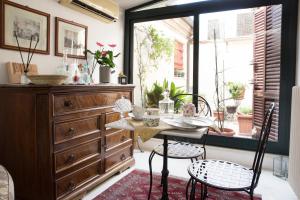 a dining room with a table and chairs and a dresser at Il Bagattino in Ferrara