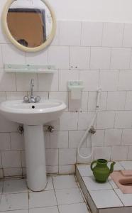 a bathroom with a sink and a mirror at Welcome Guest House in Barāniā