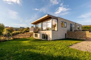 a house on a hill with a large yard at Stunning 5 Bedroom Home with Garden & Panoramic Views! in Bath