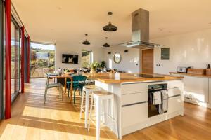 a kitchen and dining room with a table and chairs at Stunning 5 Bedroom Home with Garden & Panoramic Views! in Bath